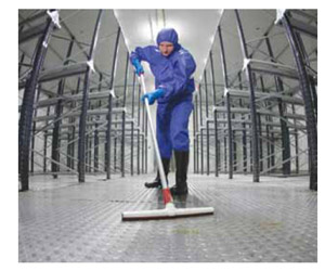 Image of worker in protective gear cleaning a floor